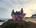 Load image into Gallery viewer, BeachMate American Flag Turkish towel used as a FlagtowelflyingonQrocks – lightweight, patriotic quick-dry towel perfect for the 4th of July, swimming, and travel.