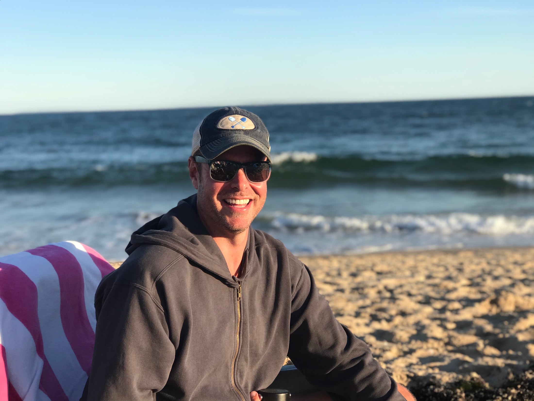Lifestyle photo at the beach wearing a Beachmate adult trucker hat
