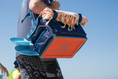 Load image into Gallery viewer, Person carrying the Beachmate System with shoulder strap to the beach