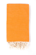 Load image into Gallery viewer, Folded orange Turkish towel with tassel fringe, studio view