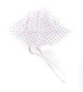 Load image into Gallery viewer, A white cotton sun hat with a dotted pattern in blue and pink, featuring adjustable ties for securing on a baby's head.