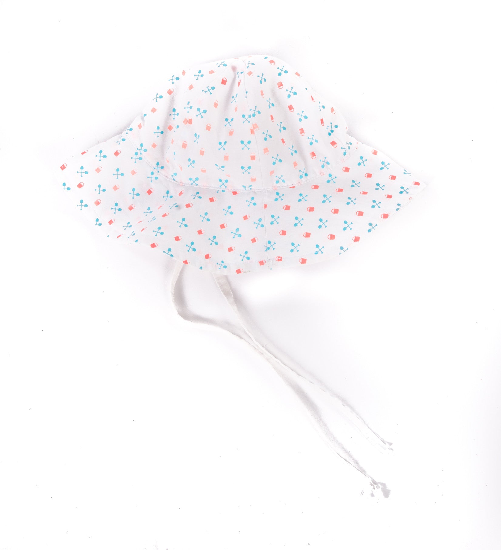 A white cotton sun hat with a dotted pattern in blue and pink, featuring adjustable ties for securing on a baby's head.