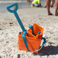 Load image into Gallery viewer, Beachmate orange bucket with blue shovel on the sand
