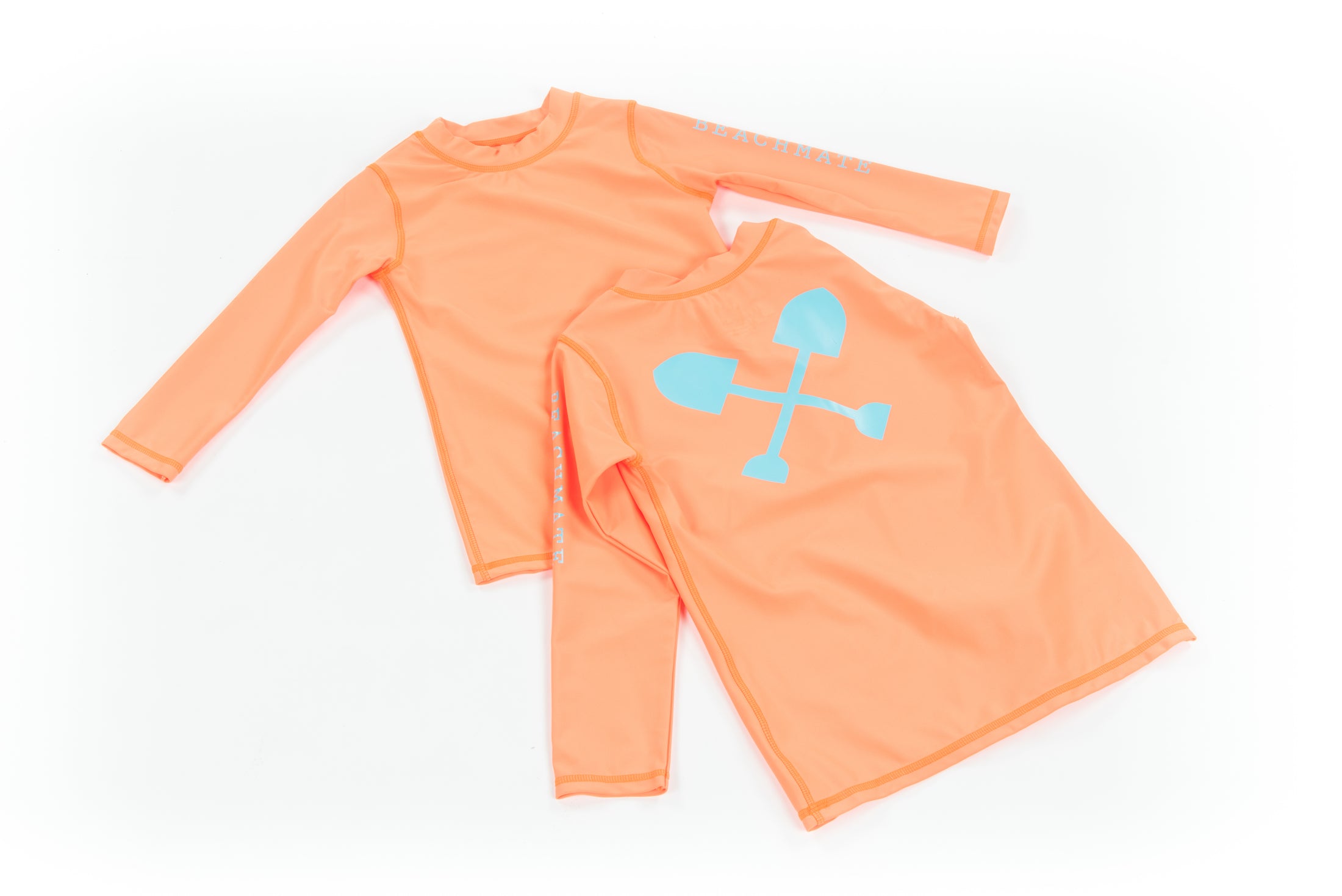 Orange kids long‑sleeve swim shirt (rash guard) with Beachmate logo, flat lay