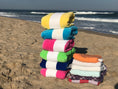 Load image into Gallery viewer, Lifestyle photo of mint Turkish, yellow,light pink towel at the beach

