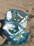 Load image into Gallery viewer, Large Beachmate accessory pouch with beach essentials inside a Beachmate bucket on the sand
